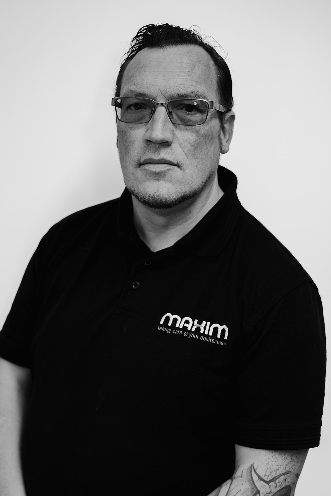 Man in Maxim branded polo shirt, black and white.