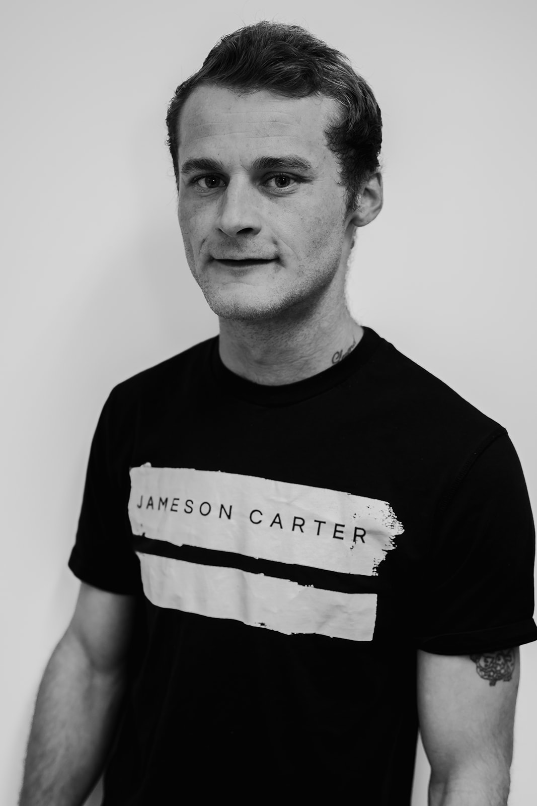 Man wearing Jameson Carter t-shirt, black and white photo.