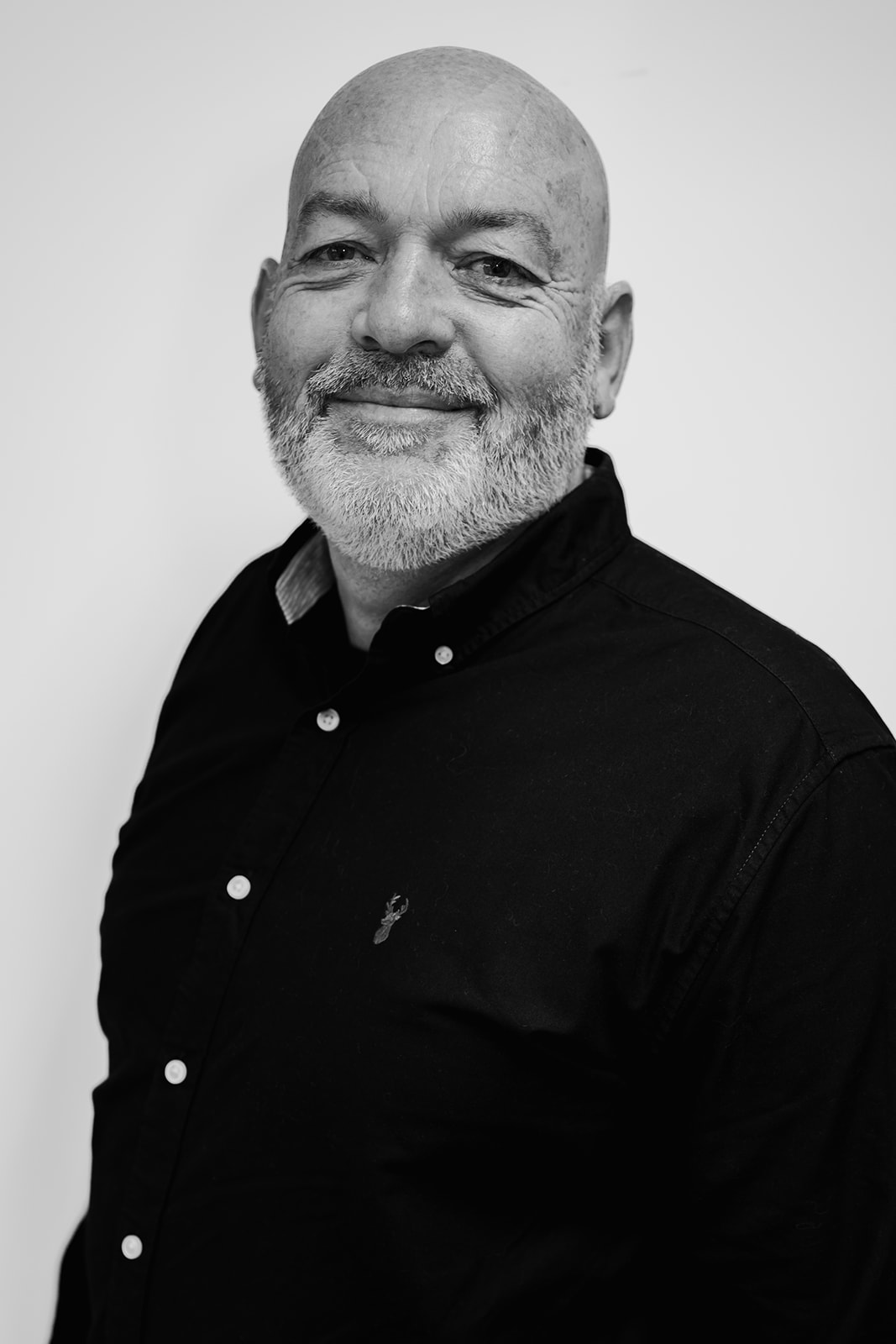 Smiling man in a black shirt, portrait.