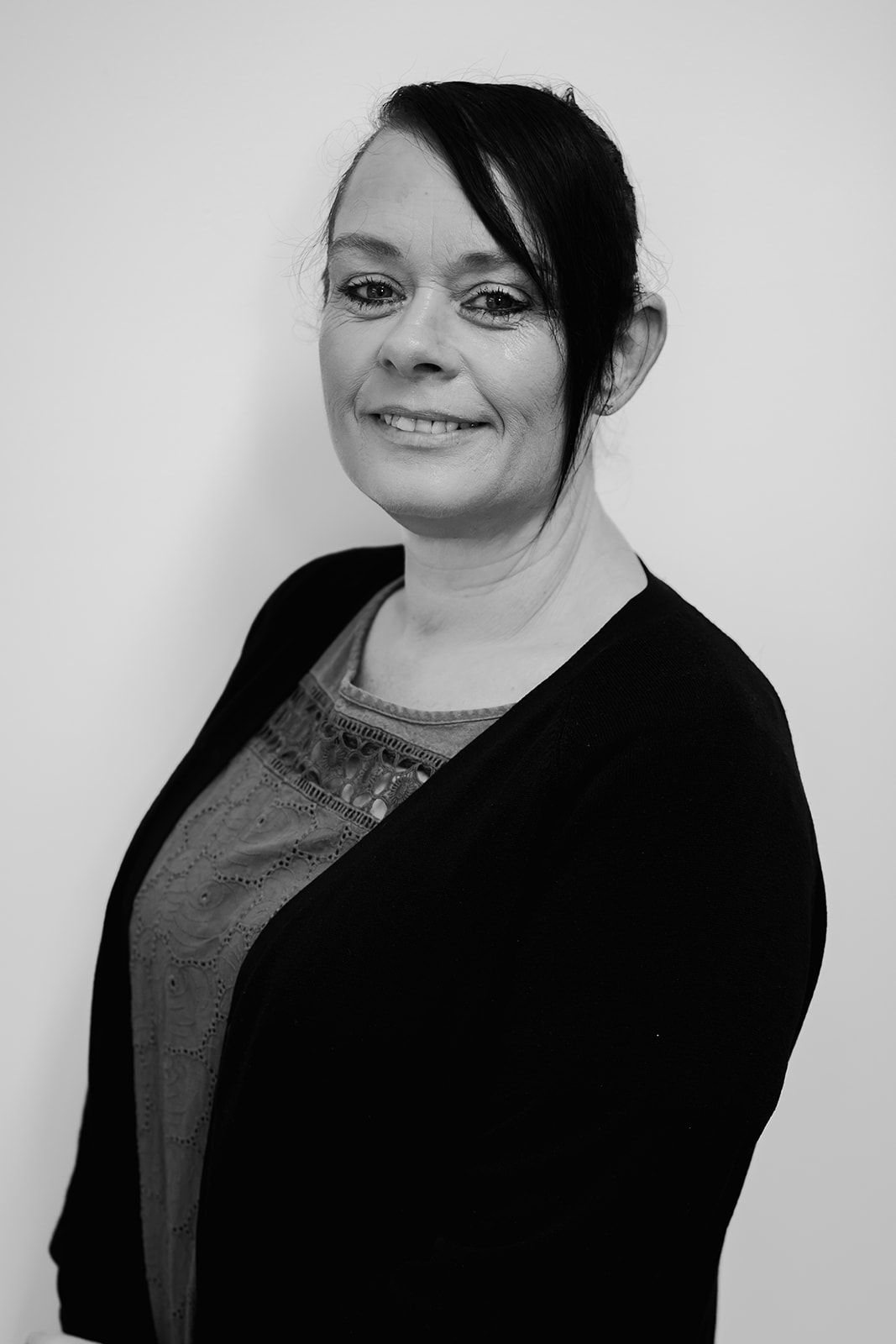 Black and white portrait of smiling woman.