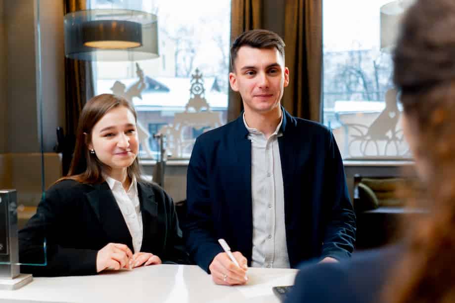 Couple checking in at hotel reception.