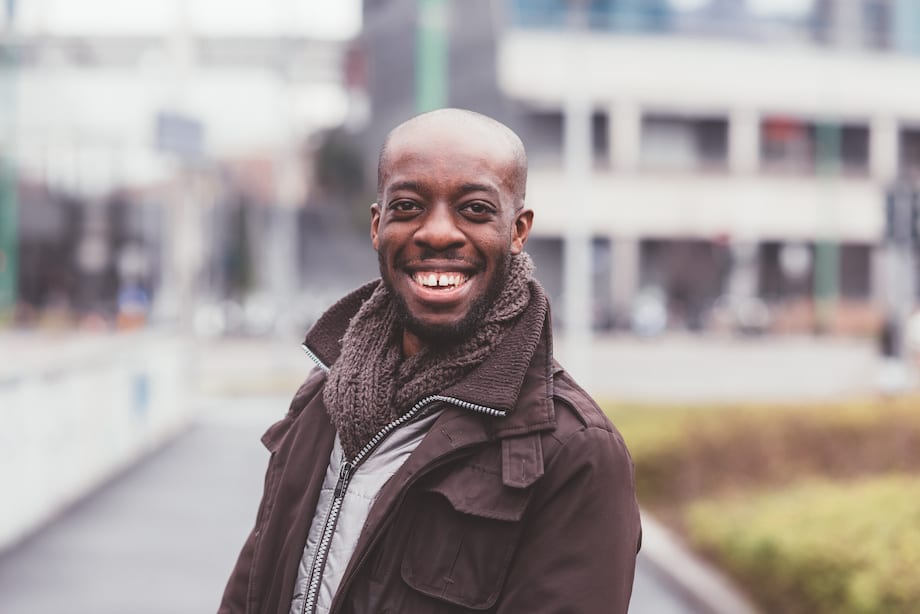 Smiling man outdoors in winter coat and scarf